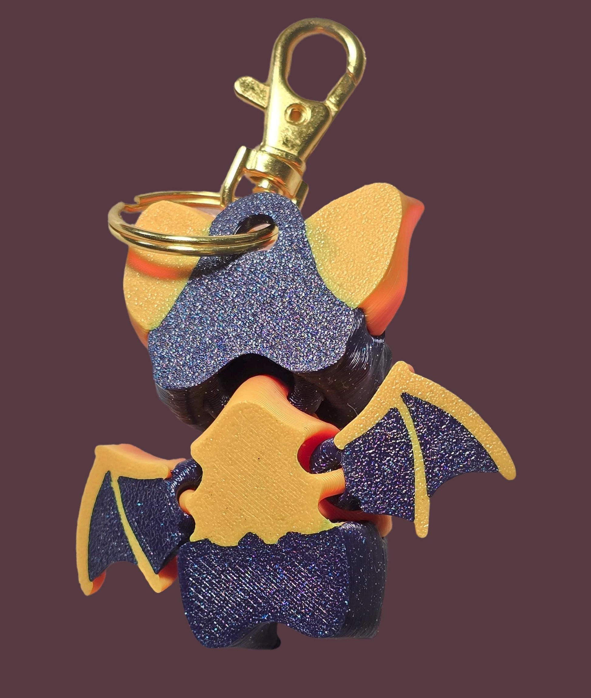 a close up of a key chain with a bat on it