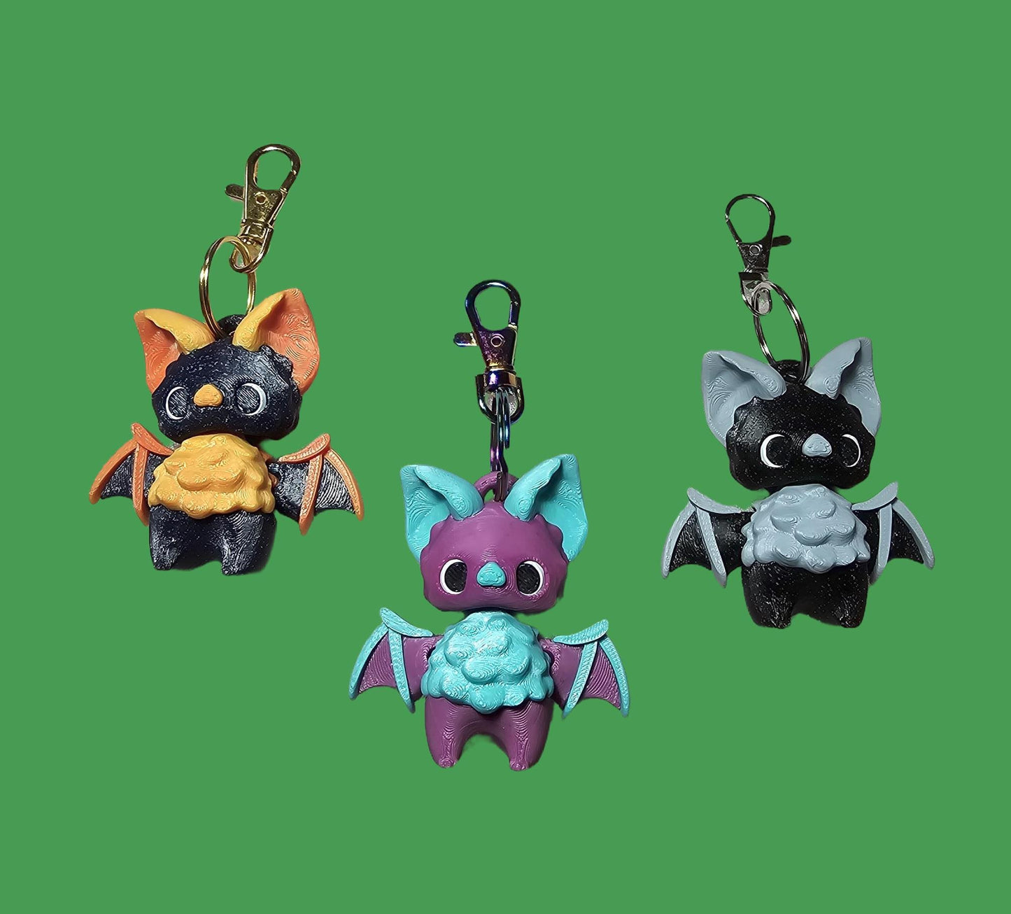 three different key chains with different designs on them