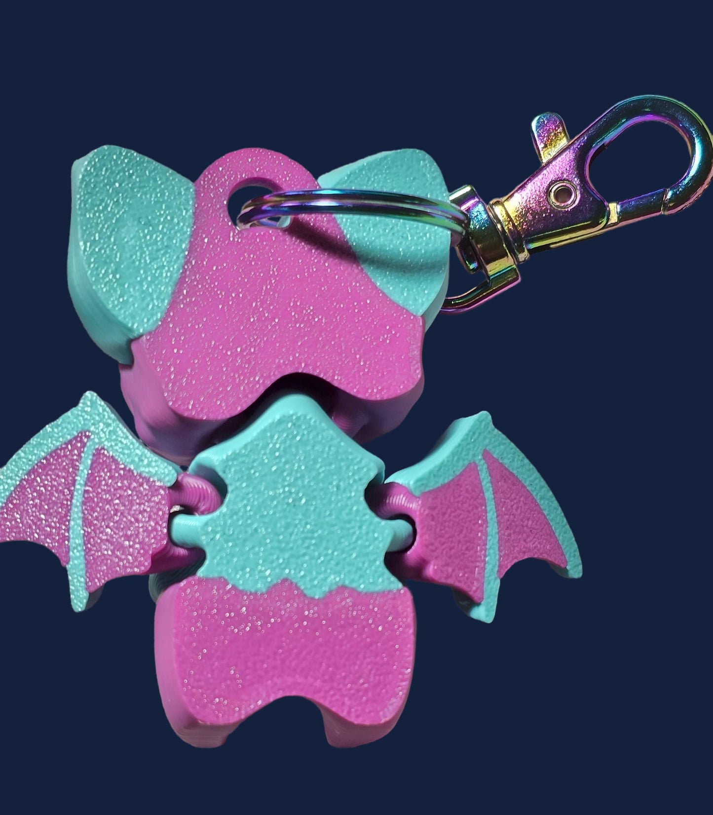 a pink and blue bat shaped key chain